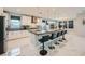 Spacious kitchen with stainless steel appliances, a large island, and sleek white cabinetry at 6834 Compass St, North Las Vegas, NV 89084