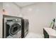 Convenient laundry room with washer, dryer, and shelving at 6834 Compass St, North Las Vegas, NV 89084