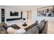 Cozy living room with a modern sofa, decorative shelves, and a mounted TV at 6834 Compass St, North Las Vegas, NV 89084
