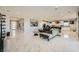 Spacious living room with marble floors, sectional sofa, and kitchen views at 6834 Compass St, North Las Vegas, NV 89084