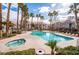 Inviting pool and spa area with lounge chairs and palm trees at 700 Carnegie St # 2914, Henderson, NV 89052