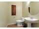 Simple bathroom with white pedestal sink and toilet at 8467 Bismark Sapphire St, Las Vegas, NV 89139