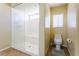 Bathroom with walk-in shower, toilet, and window at 8467 Bismark Sapphire St, Las Vegas, NV 89139