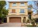 Tan two-story house with a large garage and nicely landscaped yard at 8467 Bismark Sapphire St, Las Vegas, NV 89139