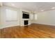 Living room with hardwood floors, fireplace, and built-in entertainment center at 8467 Bismark Sapphire St, Las Vegas, NV 89139