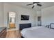 Bedroom with wood-look floors, large bed, and ensuite bathroom at 8627 Roping Rodeo Ave # 103, Las Vegas, NV 89178