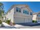 Three-story townhome with a three-car garage, walkway, and landscaping at 8627 Roping Rodeo Ave # 103, Las Vegas, NV 89178