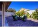 Private backyard patio with seating area and lush landscaping at 8772 Rio Grande Falls Ave, Las Vegas, NV 89178