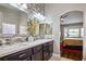 Elegant bathroom with double sinks, mosaic tile, and views into bedroom at 8772 Rio Grande Falls Ave, Las Vegas, NV 89178