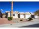 Single-story house with a two-car garage and nicely landscaped yard at 8772 Rio Grande Falls Ave, Las Vegas, NV 89178