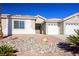 Single-story house with a two-car garage and rock landscaping at 8772 Rio Grande Falls Ave, Las Vegas, NV 89178