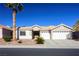 Single-story house with a two-car garage and palm trees in front at 8772 Rio Grande Falls Ave, Las Vegas, NV 89178