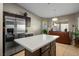 Kitchen with stainless steel appliances and an island with seating at 8772 Rio Grande Falls Ave, Las Vegas, NV 89178