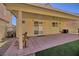 Covered patio with brick pavers and artificial turf at 8836 Big Bear Pines Ave, Las Vegas, NV 89143