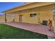 Covered patio with brick pavers and artificial turf at 8836 Big Bear Pines Ave, Las Vegas, NV 89143