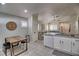 Open concept kitchen with white cabinets, concrete countertops, and eat-in area at 8836 Big Bear Pines Ave, Las Vegas, NV 89143