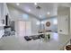 Modern kitchen with concrete countertops, stainless steel sink, and breakfast bar at 8836 Big Bear Pines Ave, Las Vegas, NV 89143