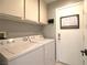 Laundry room with washer, dryer, and storage cabinets at 8836 Big Bear Pines Ave, Las Vegas, NV 89143