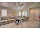 Living room with sectional sofa, coffee table, and ceiling fan at 8836 Big Bear Pines Ave, Las Vegas, NV 89143