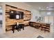 Living room with wood feature wall, large TV, and ample seating at 8836 Big Bear Pines Ave, Las Vegas, NV 89143