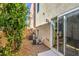 Small backyard with sliding glass door, trees and AC units at 9361 Hilgard Ave, Las Vegas, NV 89178