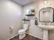 Powder room with pedestal sink and floating shelves at 9361 Hilgard Ave, Las Vegas, NV 89178