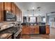 Modern kitchen with stainless steel appliances and dark wood cabinetry at 9361 Hilgard Ave, Las Vegas, NV 89178