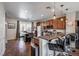 Modern kitchen with dark wood cabinets and granite countertops at 9361 Hilgard Ave, Las Vegas, NV 89178