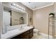 Clean bathroom with dark wood vanity and updated fixtures at 9636 Swan Bay Dr, Las Vegas, NV 89117