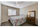 Bright bedroom with floral bedding and a ceiling fan at 9636 Swan Bay Dr, Las Vegas, NV 89117