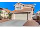 Tan two-story house with tile roof and attached garage at 9636 Swan Bay Dr, Las Vegas, NV 89117