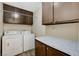 Laundry room with washer, dryer, and extra storage cabinets at 9636 Swan Bay Dr, Las Vegas, NV 89117