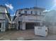 View of home under construction with visible garage and scaffolding around unfinished siding at 10039 Sir Atlas Ct, Las Vegas, NV 89148