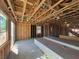 Unfinished living room with wood framing, windows, and visible staircase at 10039 Sir Atlas Ct, Las Vegas, NV 89148