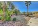 Landscaped backyard with gravel, mature trees, and desert plants at 10201 Premia Pl, Las Vegas, NV 89135