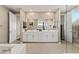 Elegant bathroom with double vanity, large mirror, and hexagon tile flooring at 10286 Jade Gardens Dr, Las Vegas, NV 89135