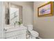 Clean and modern powder room with white vanity and toilet at 10286 Jade Gardens Dr, Las Vegas, NV 89135