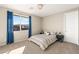 Comfortable bedroom with blue curtains and carpeting at 10286 Jade Gardens Dr, Las Vegas, NV 89135