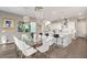 Open concept dining area with large glass table and white chairs at 10286 Jade Gardens Dr, Las Vegas, NV 89135