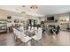 Elegant dining room with glass table, white chairs, and crystal chandelier at 10286 Jade Gardens Dr, Las Vegas, NV 89135