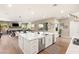 Open concept kitchen with island, white cabinets, and a view of the living room at 10286 Jade Gardens Dr, Las Vegas, NV 89135