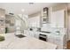 Modern kitchen with white cabinets, marble backsplash and stainless steel appliances at 10286 Jade Gardens Dr, Las Vegas, NV 89135