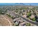 Aerial view of houses in a residential community with mountain backdrop at 10509 India Hawthorn Ave, Las Vegas, NV 89144