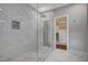 Spa-like bathroom with marble shower, glass enclosure, and modern fixtures at 10509 India Hawthorn Ave, Las Vegas, NV 89144