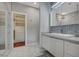 Elegant bathroom with marble tile, walk-in shower, and modern vanity at 10509 India Hawthorn Ave, Las Vegas, NV 89144