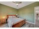 Charming bedroom with wood flooring, ceiling fan and access to hallway at 10509 India Hawthorn Ave, Las Vegas, NV 89144