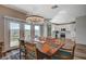 Bright dining area with a farmhouse table and chandelier at 10509 India Hawthorn Ave, Las Vegas, NV 89144