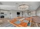 Open concept dining area with farmhouse table and chandelier at 10509 India Hawthorn Ave, Las Vegas, NV 89144