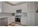 Modern kitchen with white cabinets, stainless steel appliances, and marble countertops at 10509 India Hawthorn Ave, Las Vegas, NV 89144