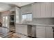 Modern kitchen features white cabinets, stainless steel appliances, and marble countertops at 10509 India Hawthorn Ave, Las Vegas, NV 89144